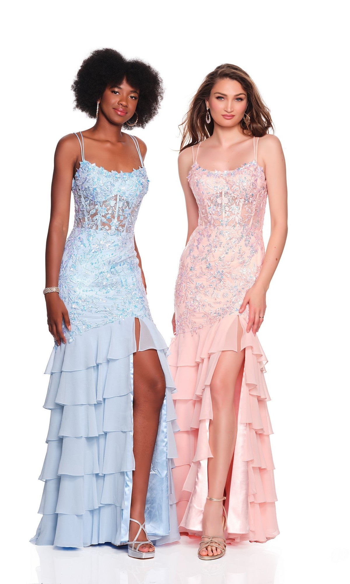 Two women stand side by side in pastel long prom dresses—one in light blue chiffon and one in pale pink—both with lace details, thigh-high slits, and ruffles, inspired by the stylish Dave and Johnny 12671 design.
